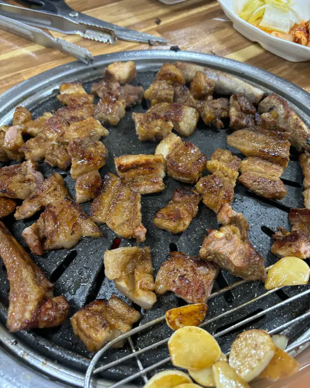 마장동숯불구이 경주본점 돼지 양념갈비 — 전지·목살·뒷다리 섞지 않은 갈빗살 그대로 양념해 숯불에 구워지는 모습