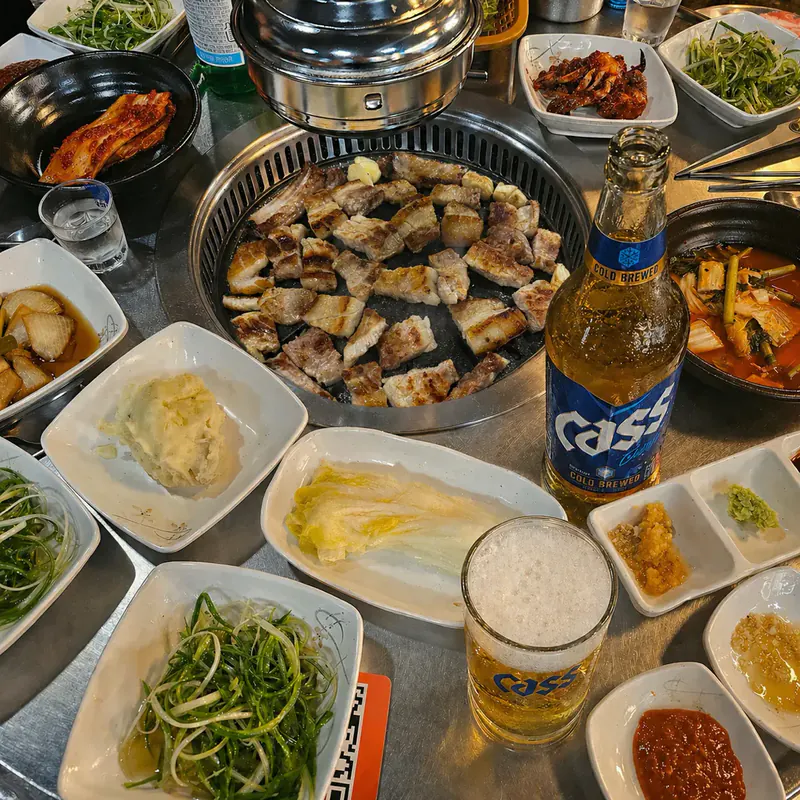 마장동숯불구이 황성점 시그니처 메뉴 — 돼지 생갈비가 숯불에 노릇하게 구워지는 모습