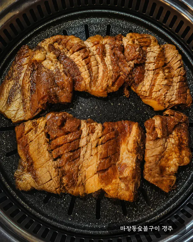 불판 가득 노릇하게 구워진 돼지 양념갈비 오버헤드 컷 — 컷팅 후 볶듯이 익힌 마무리 단계